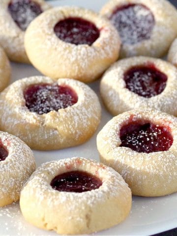 raspberry jam cookies on a white plate