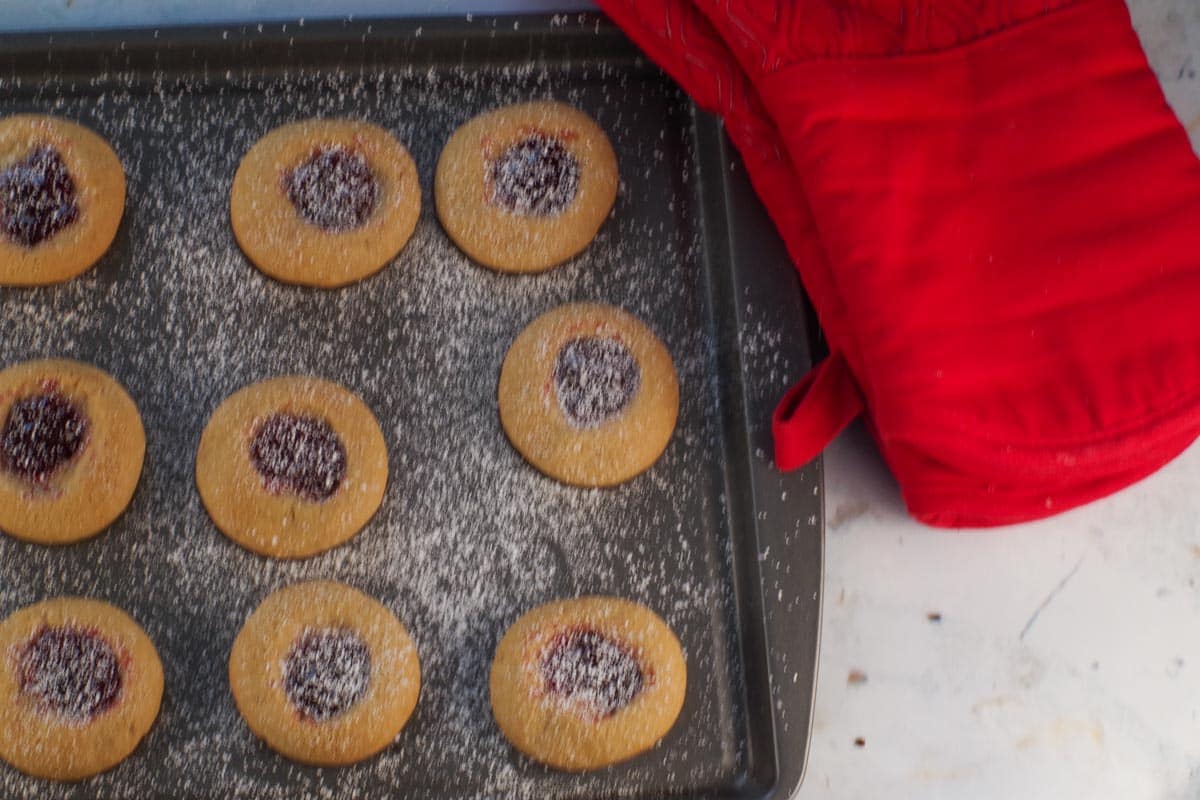 Baked jam filled cookies sprinkled with powdered sugar.