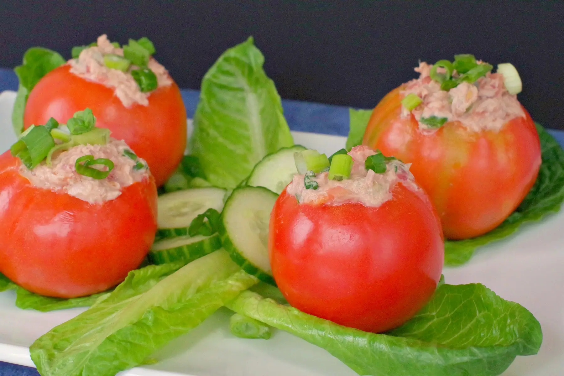 Stuffed Tomatoes with Tuna on platter with lettuce and cucumbers