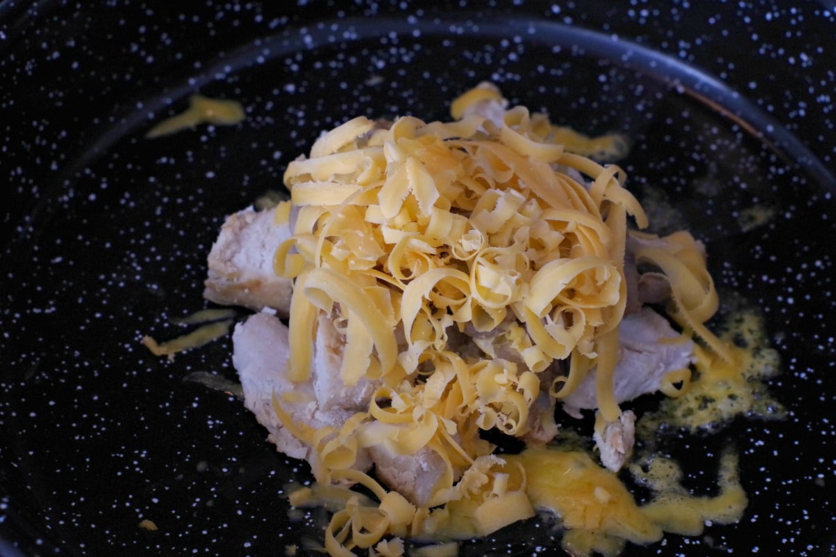 cheese grated onto sauteed mushrooms on diced chicken breast