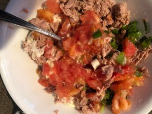 insides of tomato mixed with other ingredients and tuna