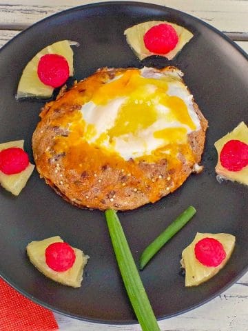 egg in a hole with pineapple, raspberry and green onion (made to look like a flower)