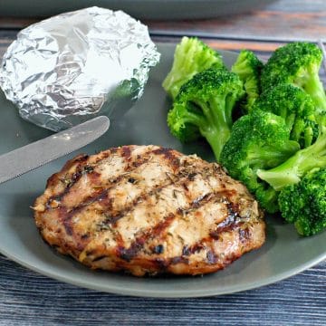 Maple lemon pork on a plate with broccoli and baked potato in foil