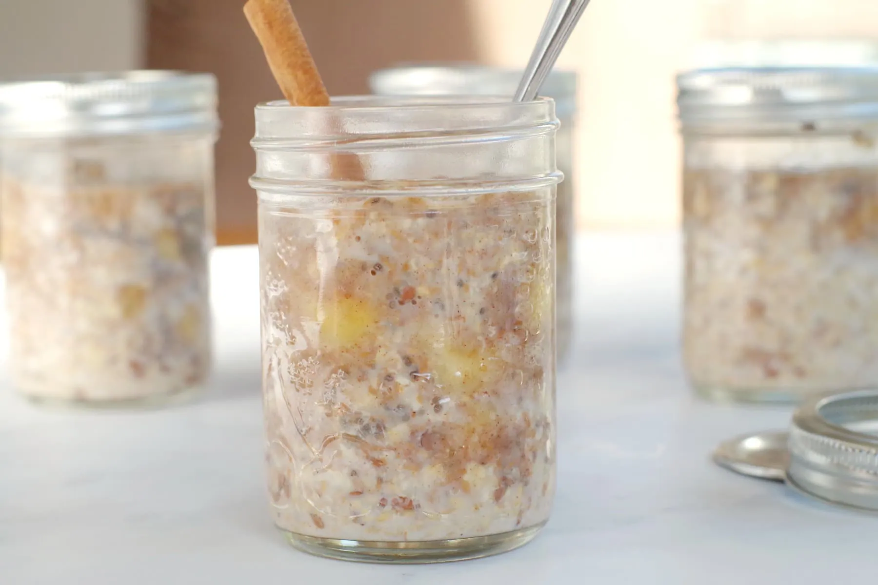 Bananas Foster Overnight Oats in a jar with more in background