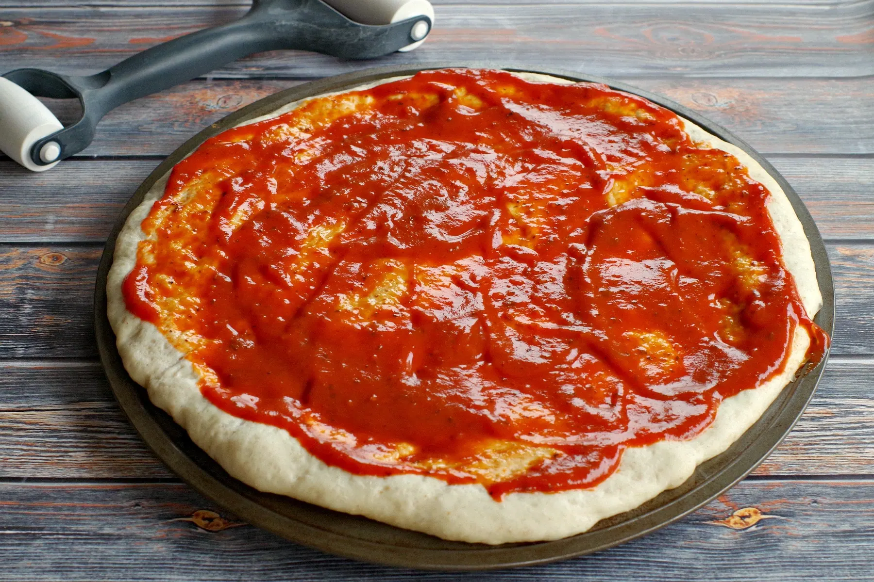 pizza dough with sauce