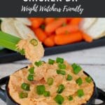 Pinterest pin with white text on light black background and photo of a piece of celery being dipped into buffalo chicken dip with a tray of veggies and crackers in the background