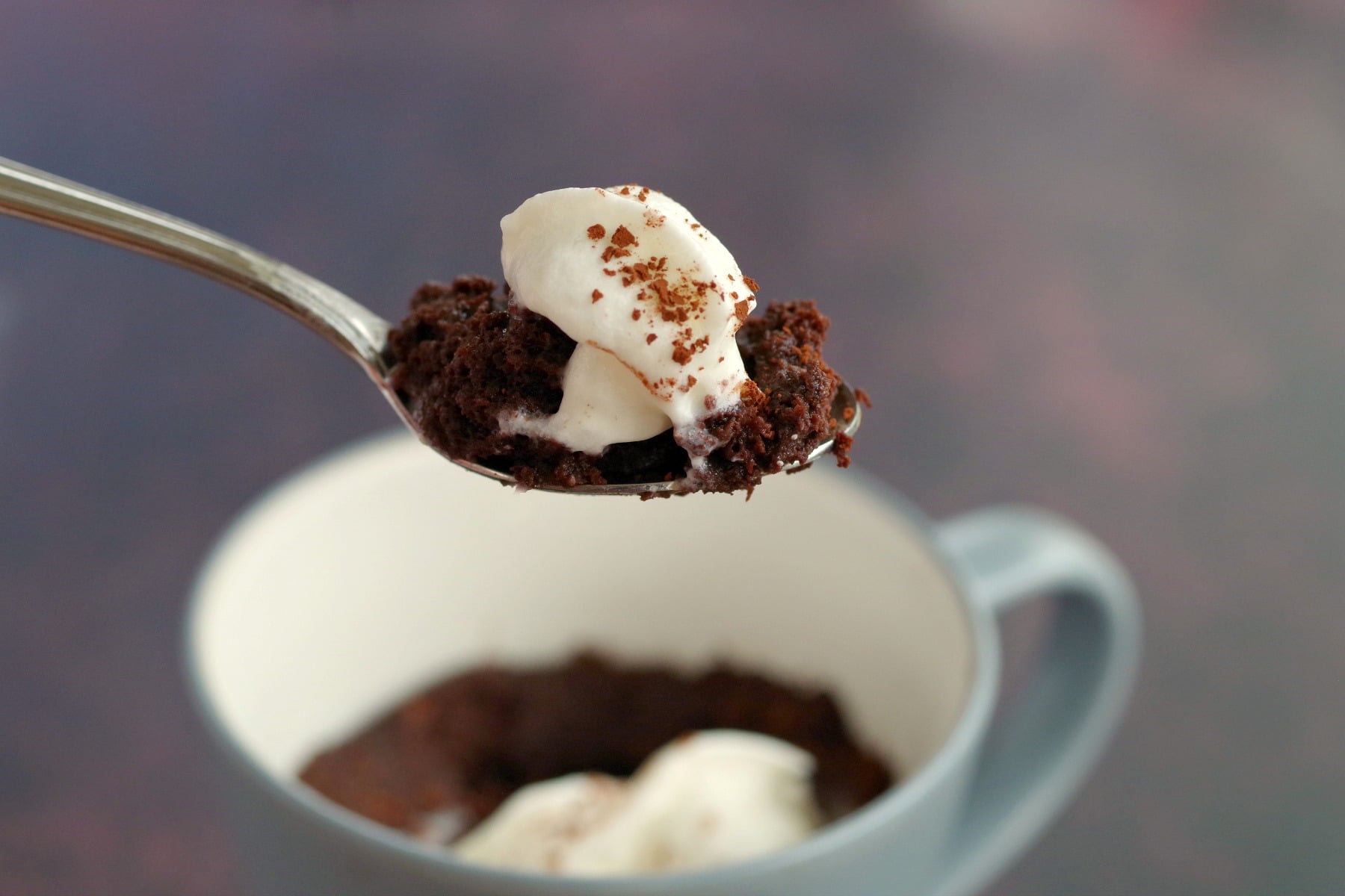 chocolate mug cake being held up on a spoon