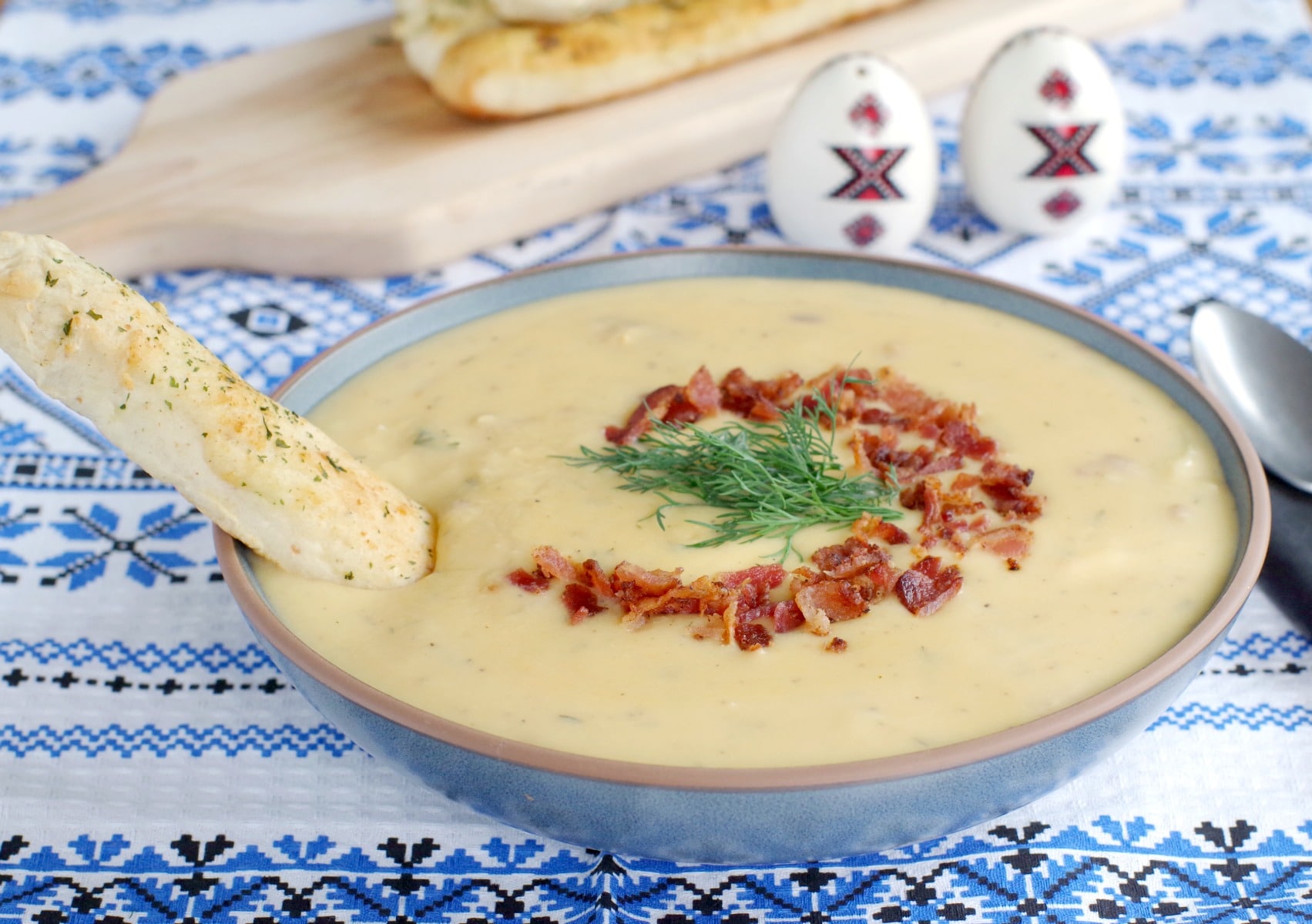 Loaded pierogi soup with a bread stick