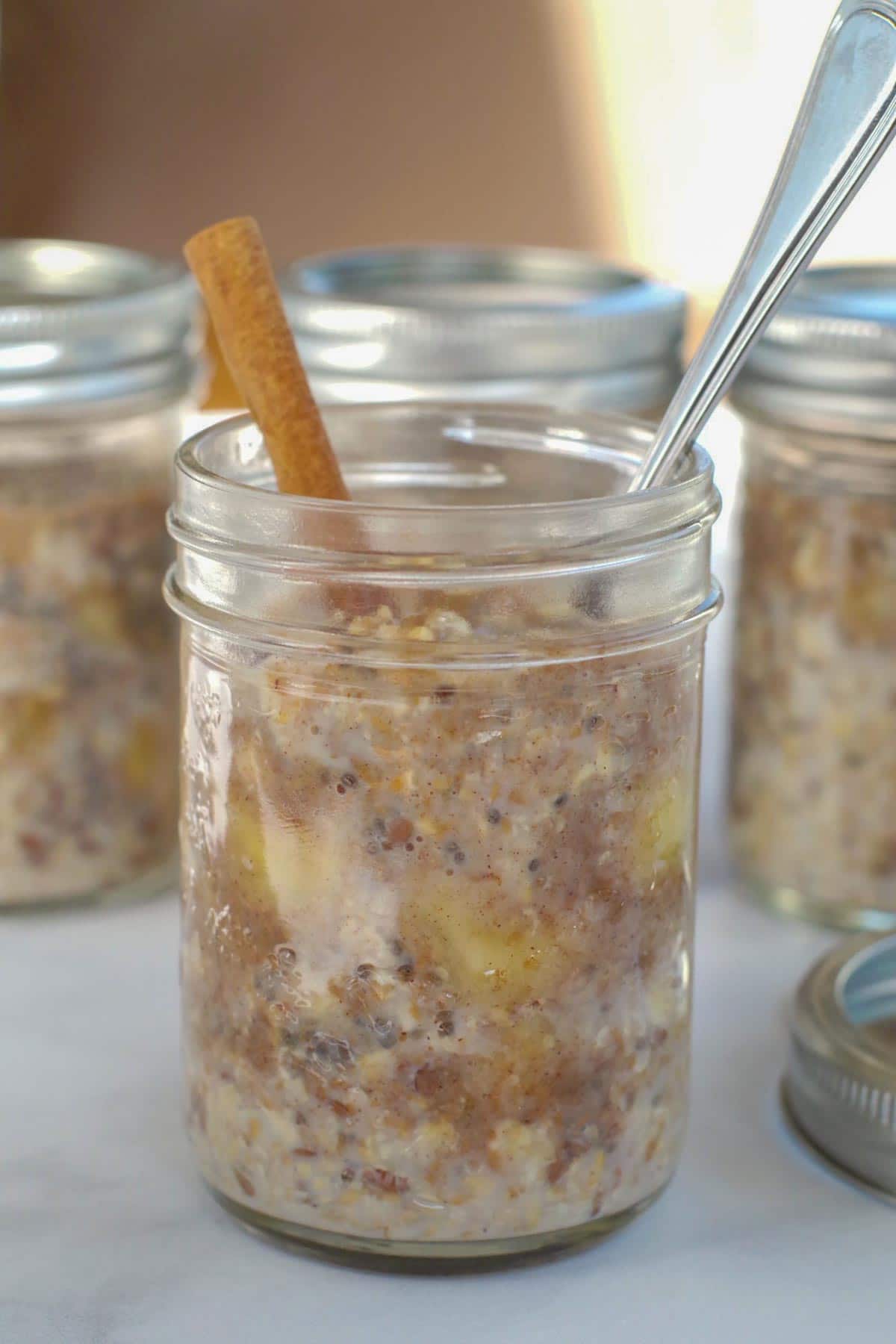 Bananas Foster Overnight Oats in a jar with jars in overnight oats behind