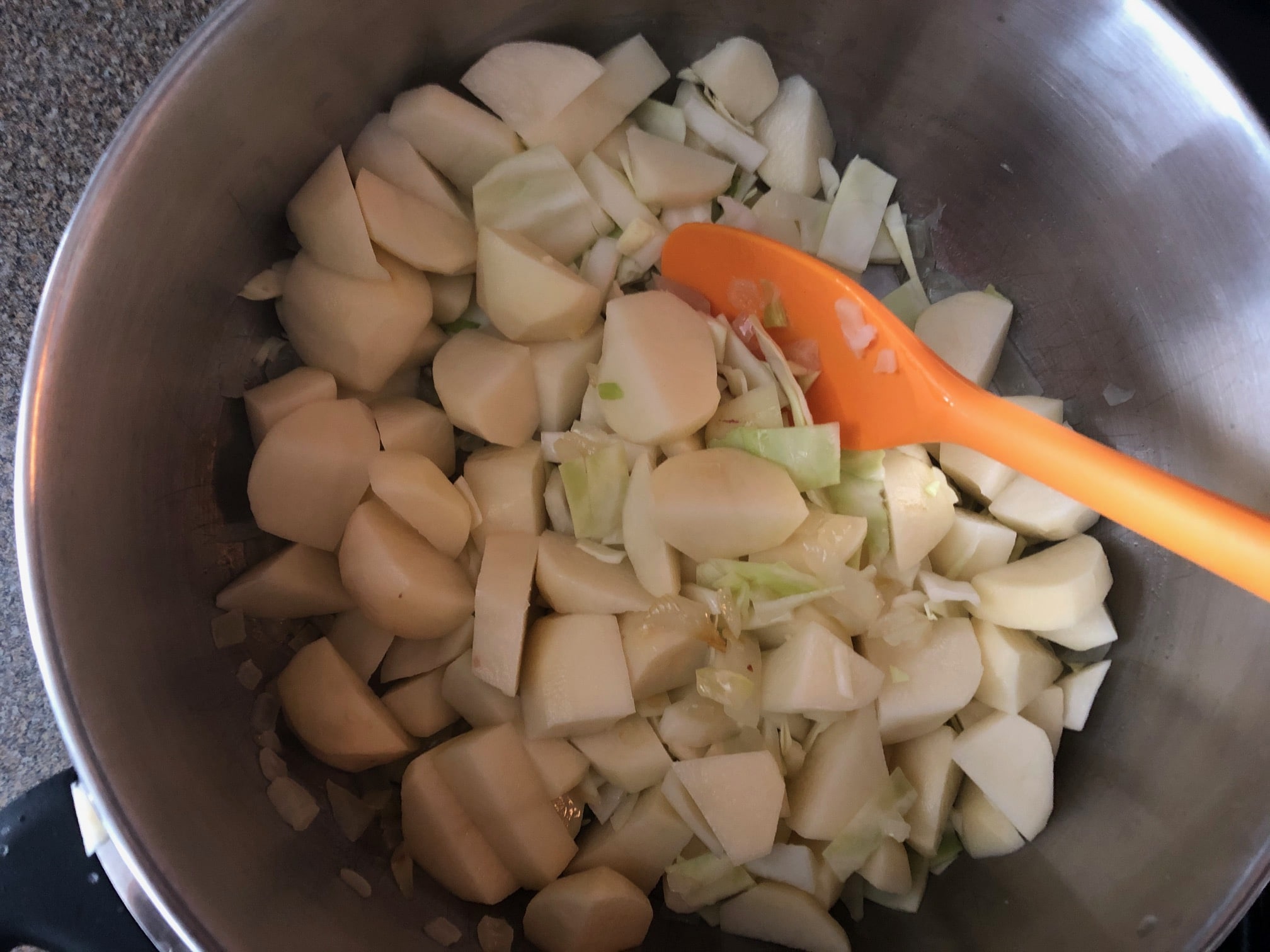 cabbage, celery seed and chicken stock added to butter and onions in soup pot