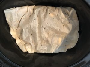packet placed in bottom of slow cooker