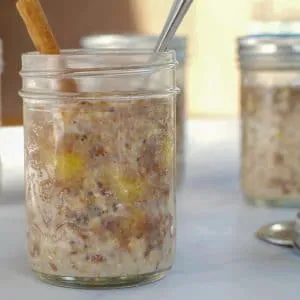 Bananas Foster Overnight Oats in a jar with jars in overnight oats behind