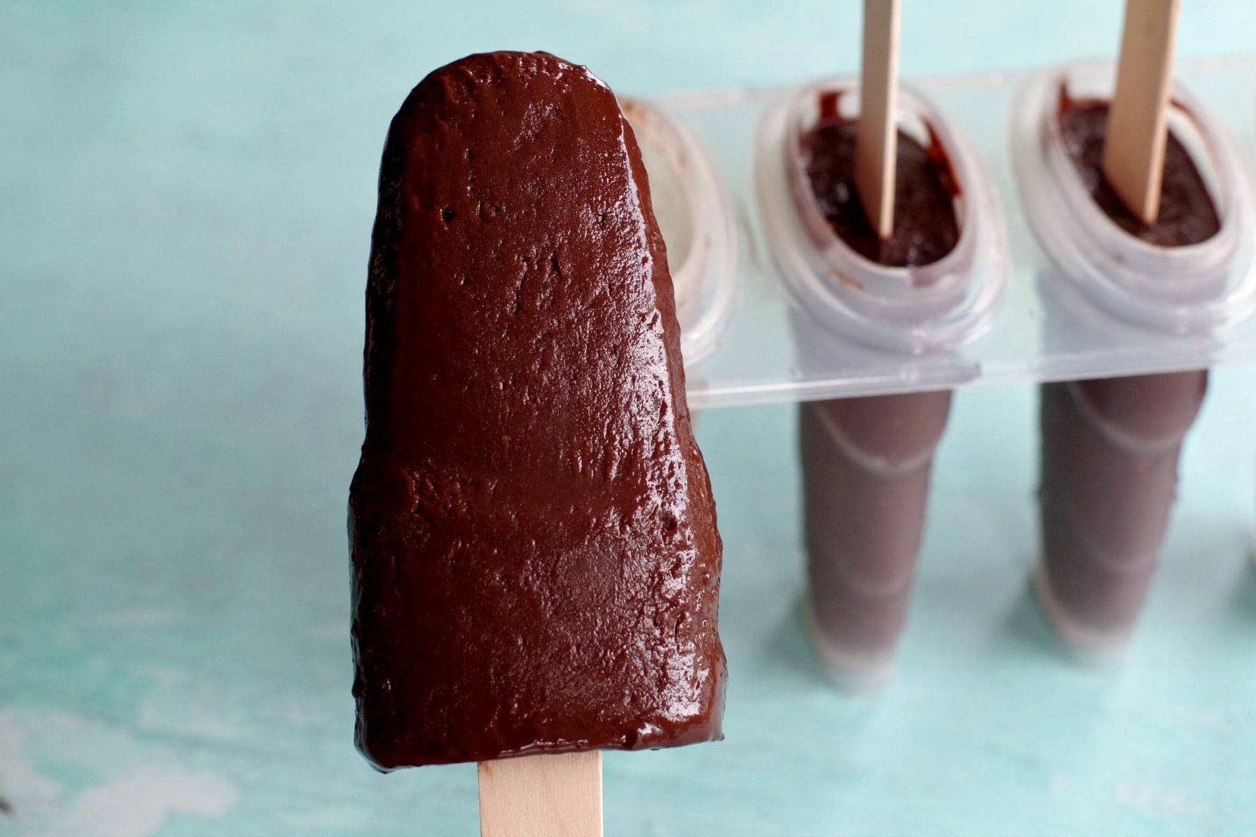 Chocolate Banana Popsicle in front of popsicle mold