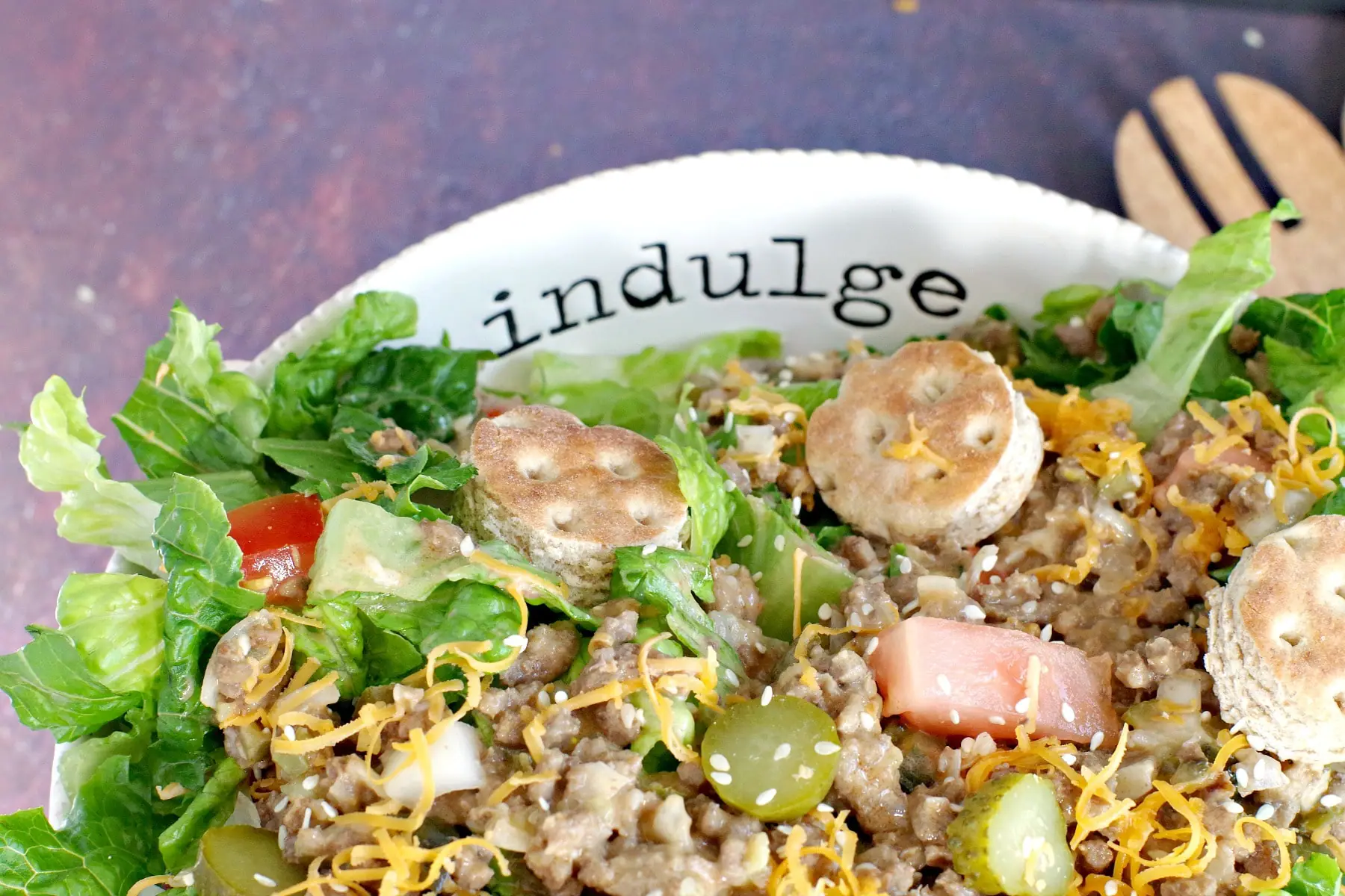Big Mac salad (from top) in white bowl) with word "indulge" written on bowl