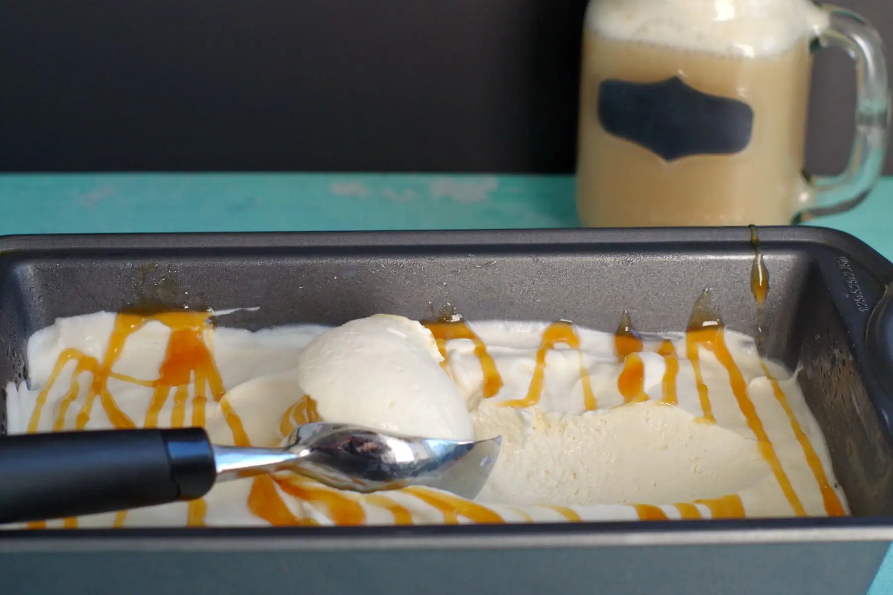 Frozen butterbeer ice cream in loaf pan with ice cream scooop