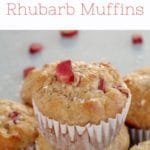rhubarb muffin stacked on top of other rhubarb muffins with a piece of rhubarb on top