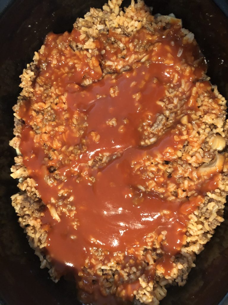meat and rice mixture with tomato soup on top