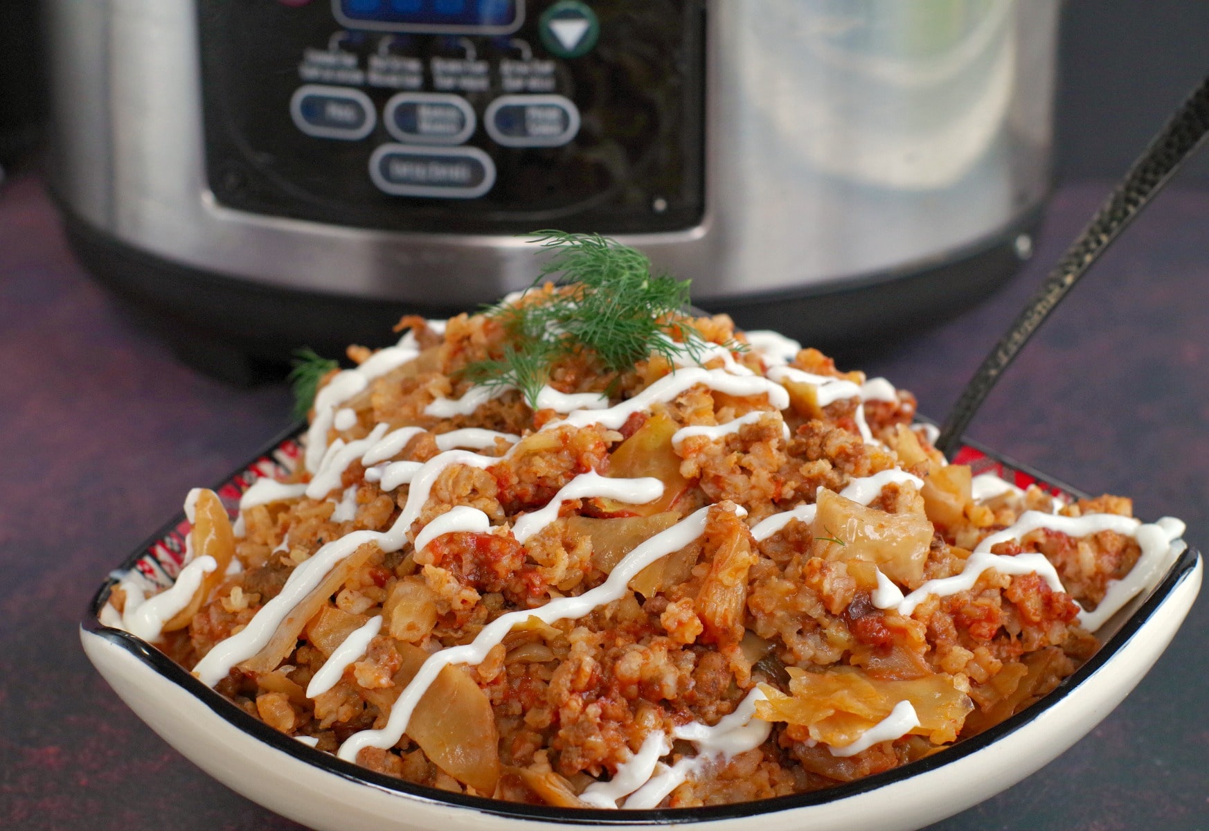 lazy slow cooker cabbage rolls in bowl with slow cooker behind