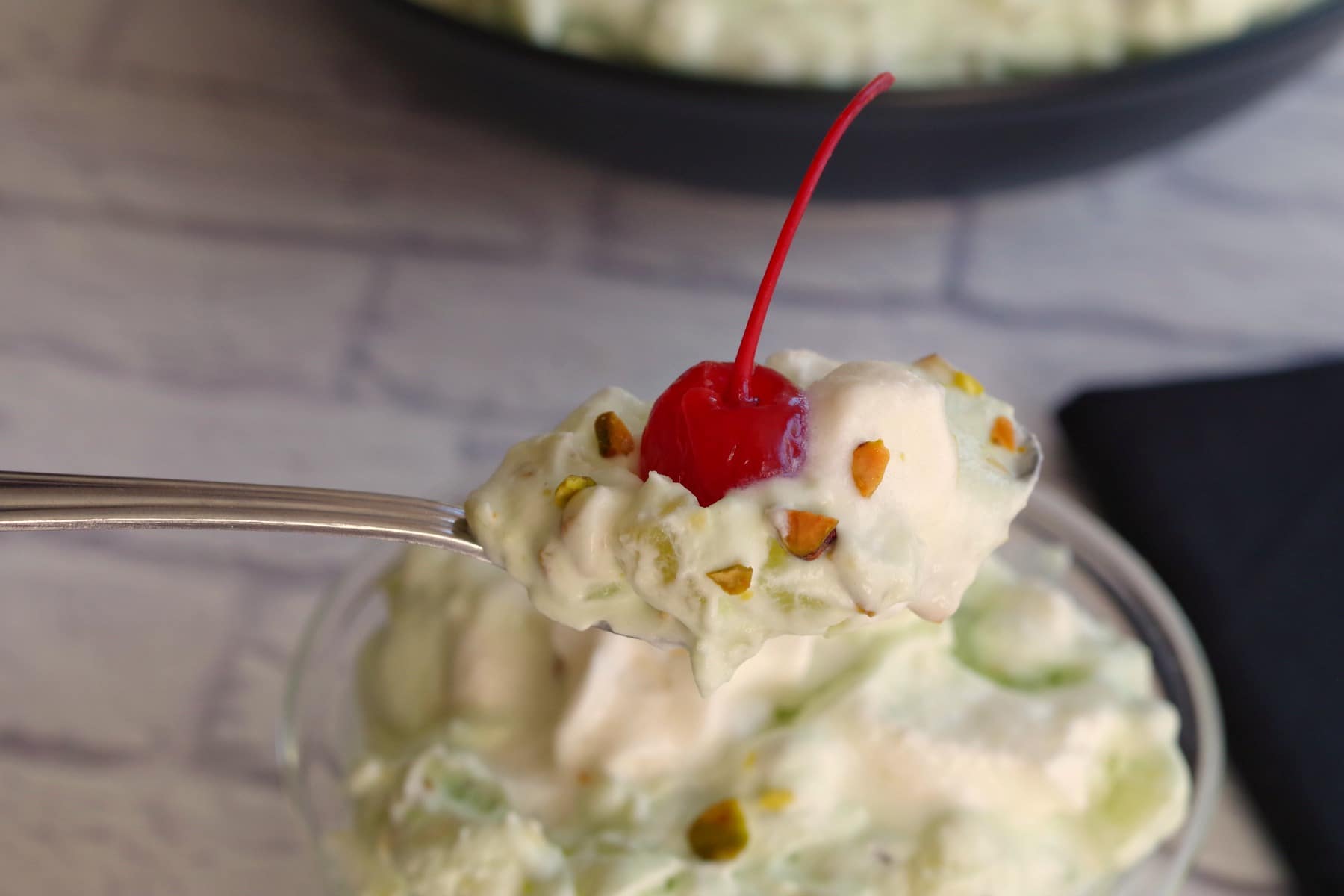 pistachio delight being held up on a spoon