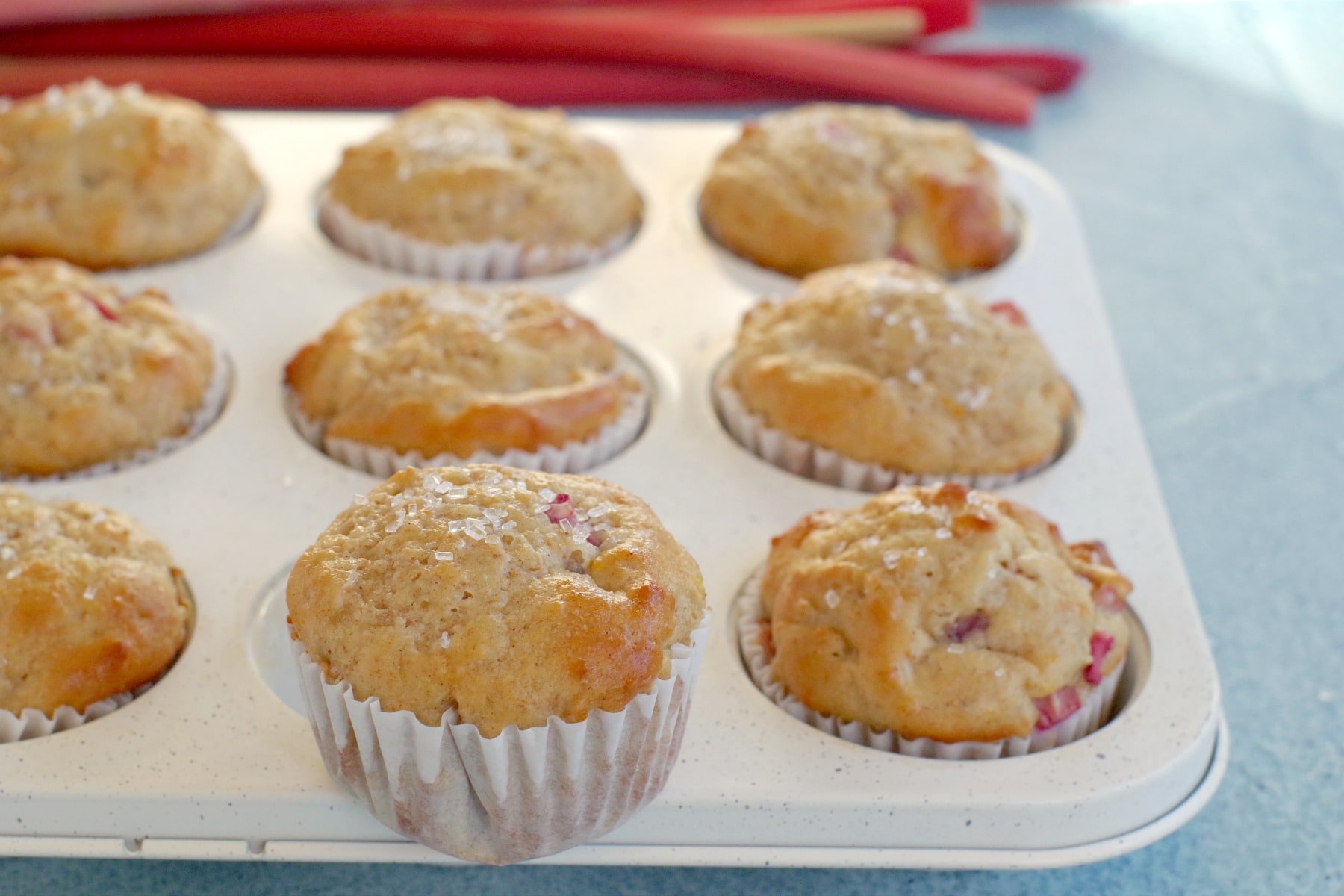 rhubarb muffin on top of a muffin tin