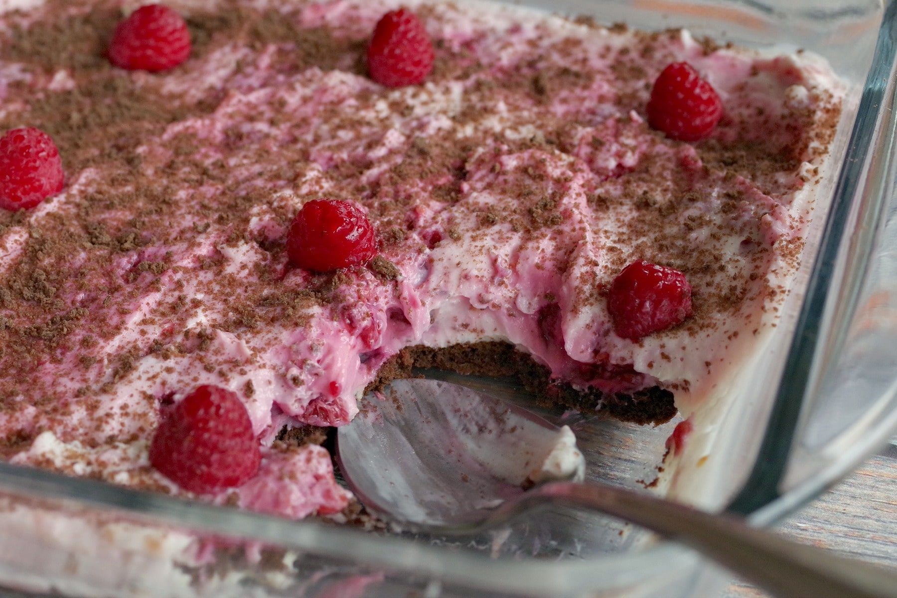 weight watchers white chocolate raspberry cheesecake dessert in glass dish with spoon