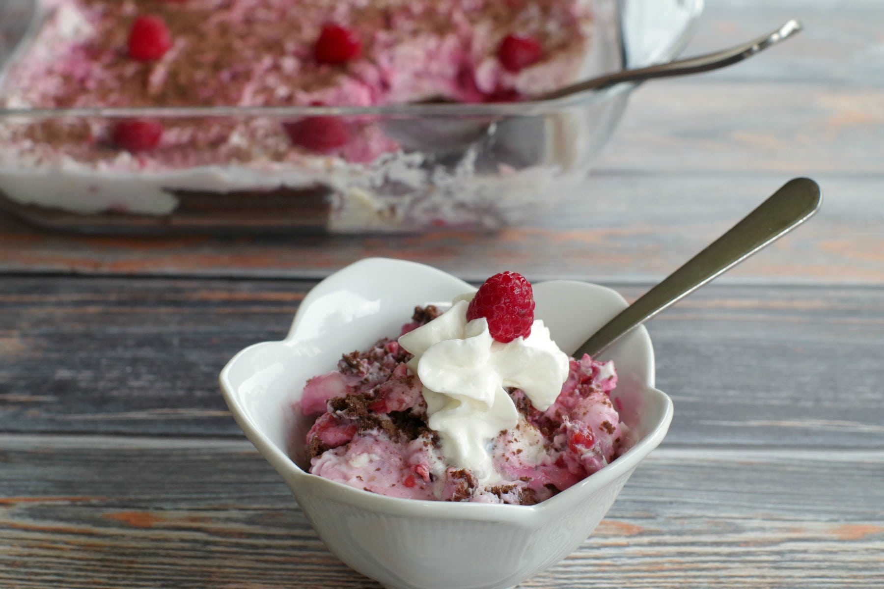 weight watchers white chocolate raspberry cheesecake dessert in white dish with glass dish in background