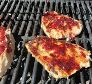 cranberry glaze on chicken on grill