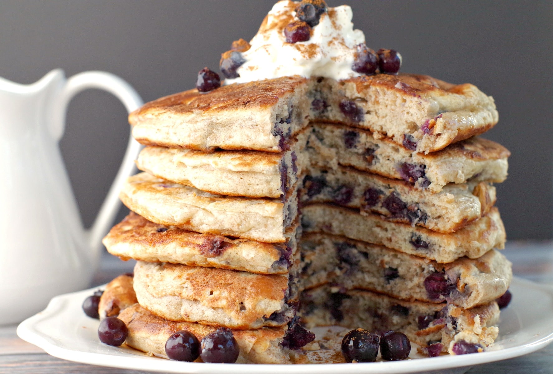 stack of Saskatoon Berry Pancakes with pancakes cut out of middle