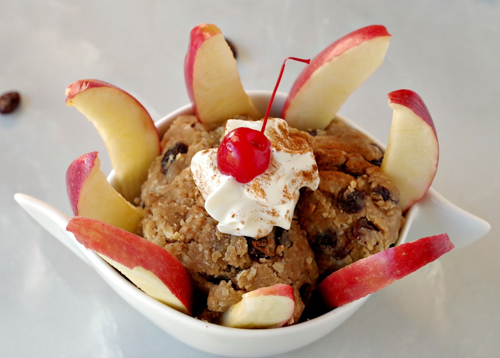 apple pieces surrounding the inside rim of a bowl of cookie dough dip