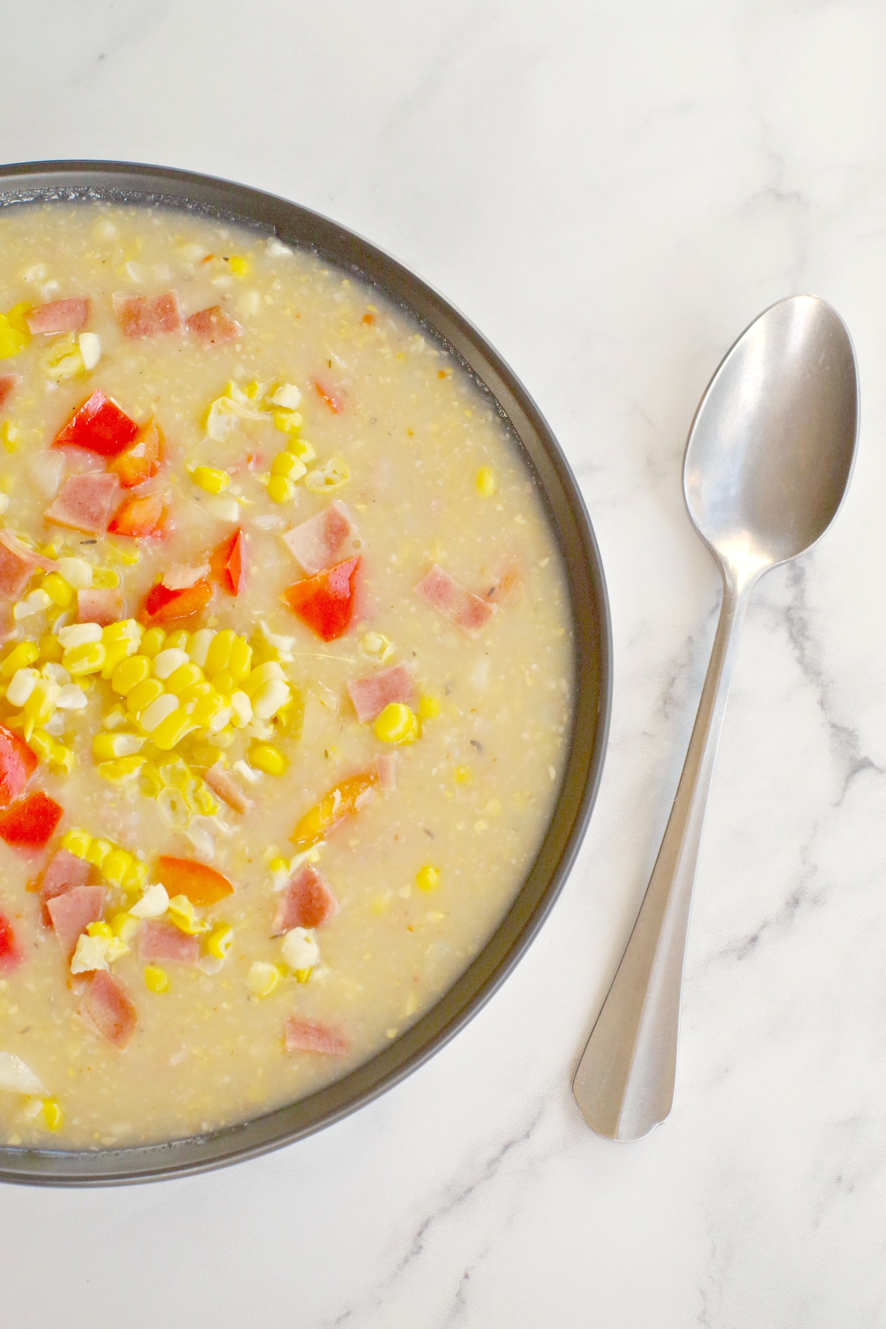bowl of corn chowder with spoon