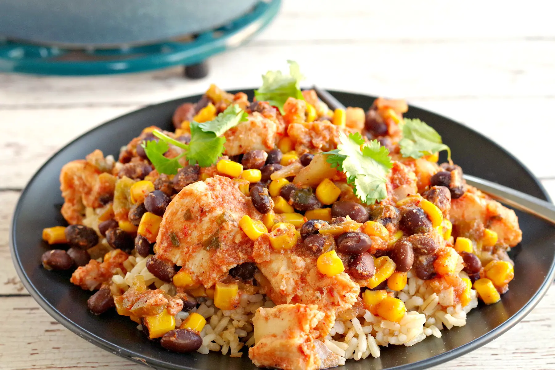 slow cooker mexican chicken over rice on black plate