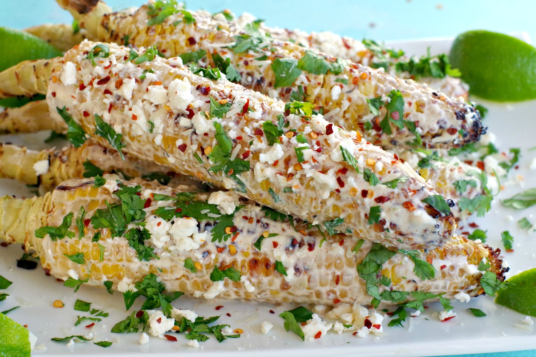 grilled mexican street corn on a white platter