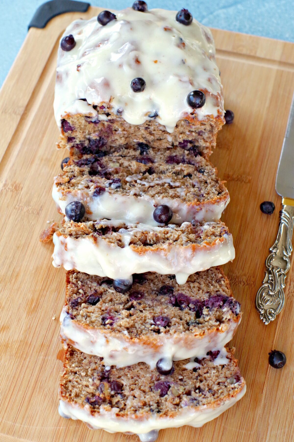 Saskatoon berry loaf sliced on a cutting board