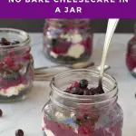 pin with text and photo of 4 jars of No Bake Saskatoon berry cheesecake (one in front with spoon)