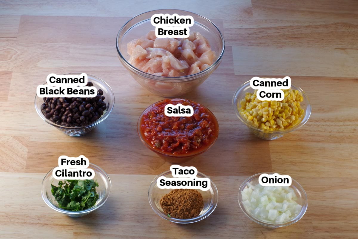 ingredients in slow cooker Mexican Chicken in glass bowls, labelled