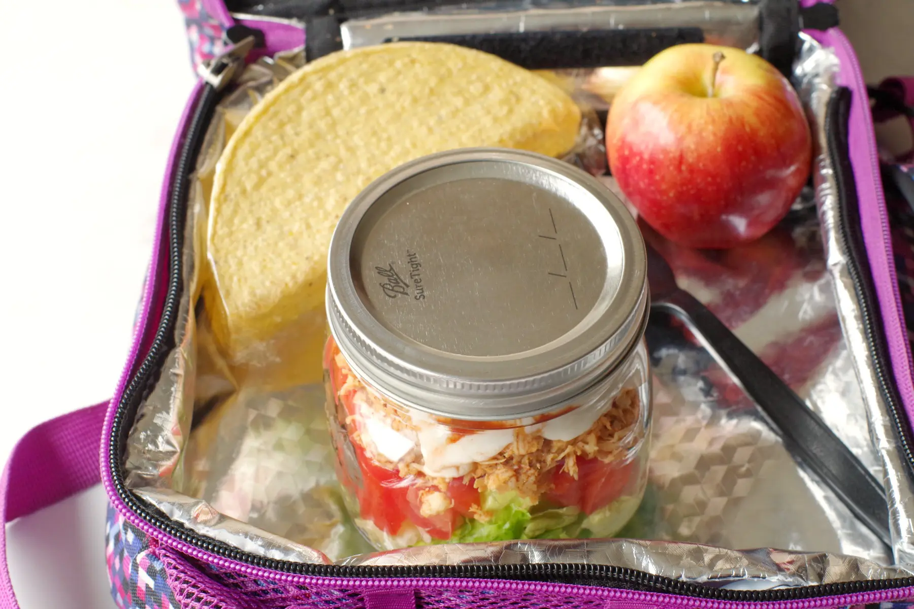 mason jar chicken taco salad in lunch bag with taco shell and apple