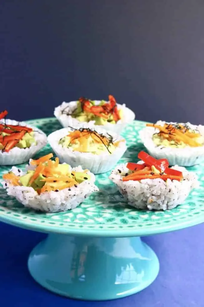 Muffin tin sushi cups on blue platter