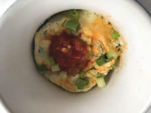 mug omelette garnished with salsa