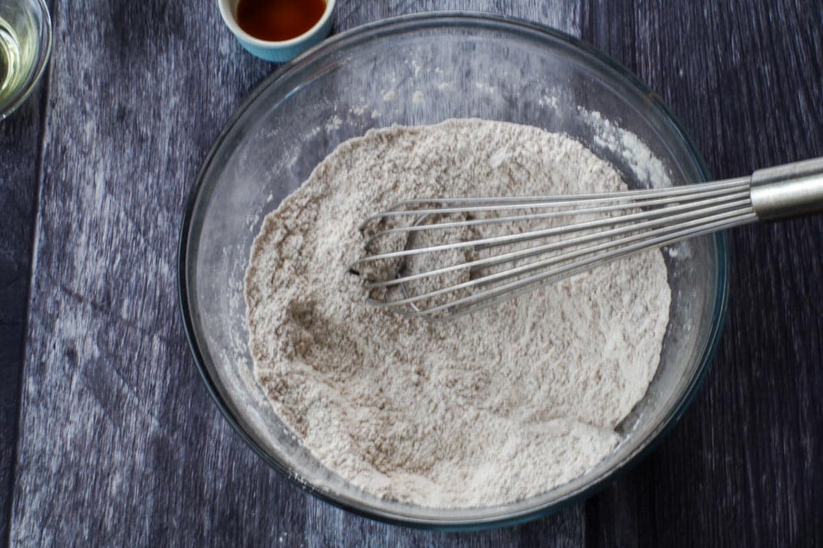 pumpkin sheet pan pancakes dry ingredients in a glass bowl with a whisk