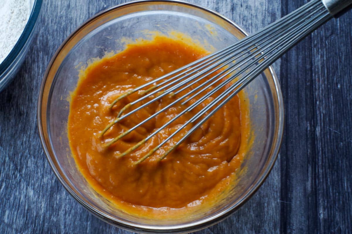 pumpkin sheet pan pancakes wet ingredients in a glass bowl with a whisk