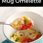 Pinterest pin with black text on top and bottom and photo ofmicrowave mug omelette being held up on spoon over blue mug