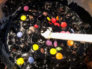 chopped Kit Kats, smarties and crushed Oreos added to black condensed milk mixture