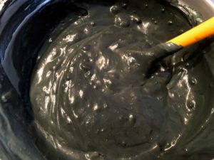 whipped cream folded into black condensed milk mixture