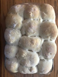 baked/lightly browned dinner buns in a glass 9X13 dish