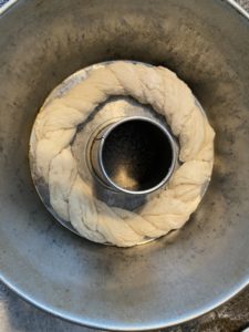 large rope of kolach on bottom of angel food cake pan