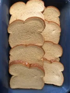 bread layered in bottom of casserole dish, overlapping