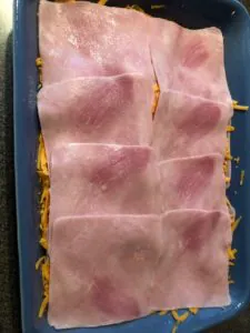 Ham slices over cheese and bread