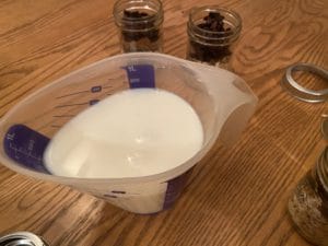 extracts added to milk with oatmeal jars in background