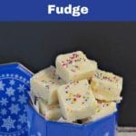Pinterest pin with white text on blue background on top and bottom. Photo of sugar cookie fudge in blue container in middle of pin