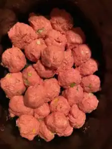 raw slow cooker turkey meatballs in the bottom of slow cooker